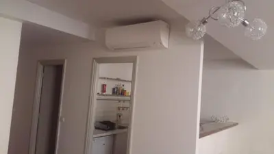 a room with a ceiling fan and a kitchen at Appartement coeur du vieux Nice in Nice