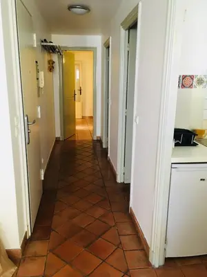 a hallway of a house with a tile floor at Appartement coeur du vieux Nice in Nice