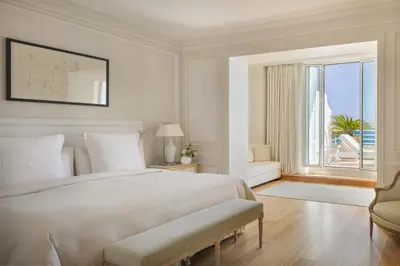 a living room with a couch and a table at Grand-Hôtel du Cap-Ferrat, A Four Seasons Hotel in Saint-Jean-Cap-Ferrat