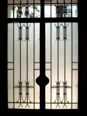 a window with a view of a street through it at Nice Appart in Nice