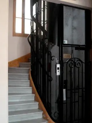 a staircase with a wrought iron railing and a stair case at Nice Appart in Nice