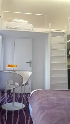 a bedroom with a bed and a desk and bunk beds at Nice Appart in Nice
