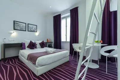 a hotel room with a bed and a staircase at Nice Appart in Nice