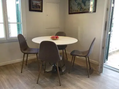 a table and chairs with a bowl of fruit on it at Appartement Tout Confort avec Terrasse in Nice