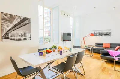 a living room with a white table and chairs at CARRE D'OR TERRACE AP4015 NICE by Riviera Holiday Homes in Nice
