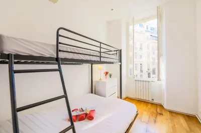 a bedroom with a bunk bed with a ladder at CARRE D'OR TERRACE AP4015 NICE by Riviera Holiday Homes in Nice