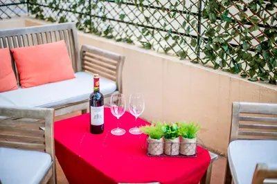a table with a bottle of wine and two glasses at CARRE D'OR TERRACE AP4015 NICE by Riviera Holiday Homes in Nice