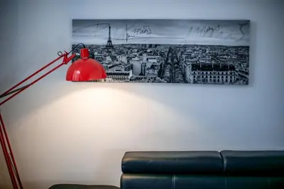 a red lamp in a room with a picture of a city at CARRE D'OR TERRACE AP4015 NICE by Riviera Holiday Homes in Nice