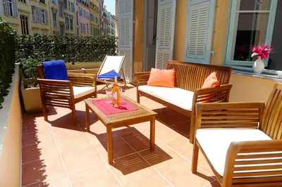 a group of chairs and a table on a patio at CARRE D'OR TERRACE AP4015 NICE by Riviera Holiday Homes in Nice