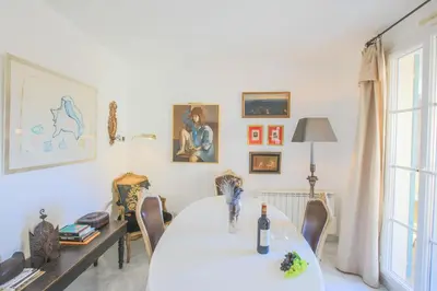 a dining room with a white table and chairs at La Providence Nice in Nice
