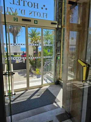 an entrance to a hotel with the door open at Hotel Flots d'Azur Promenade des Anglais in Nice