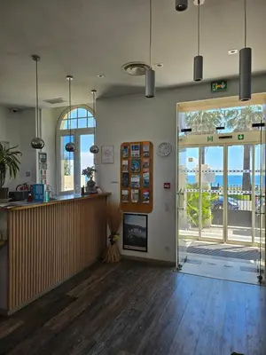a lobby of a restaurant with a counter and a door at Hotel Flots d'Azur Promenade des Anglais in Nice