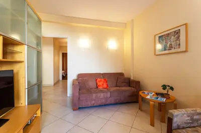 a living room with a couch and a table at LE FRANCE-MASSENET AP3015 by Riviera Holiday Homes in Nice