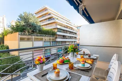 a balcony with a table with food on it at LE FRANCE-MASSENET AP3015 by Riviera Holiday Homes in Nice