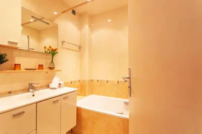 a bathroom with a bath tub and a sink at LE FRANCE-MASSENET AP3015 by Riviera Holiday Homes in Nice