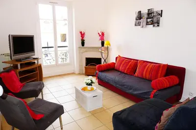 a living room with a couch and two chairs and a television at LIBERATION - Nice in Nice