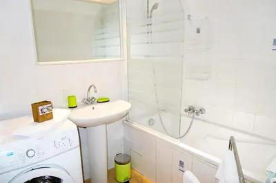 a bathroom with a sink and a washing machine at LIBERATION - Nice in Nice