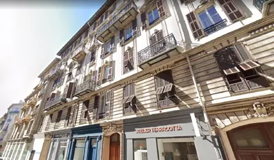 a tall white building with windows and balconies on it at LIBERATION - Nice in Nice