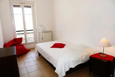 a bedroom with a white bed and a window at LIBERATION - Nice in Nice