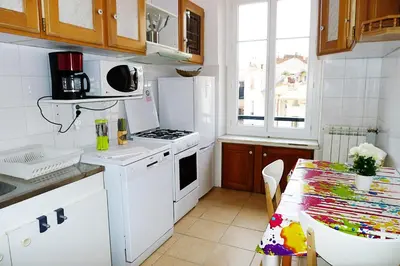 a kitchen with a table and a white stove top oven at LIBERATION - Nice in Nice