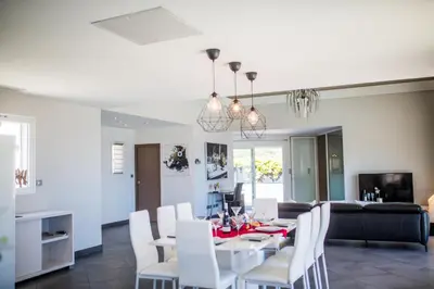 a dining room and living room with a table and chairs at CORNICHE D'ARGENT - Nice in Nice