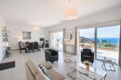 a living room with a couch and a table at Vinaigrier Hills VI3086 by Riviera Holiday Homes in Nice
