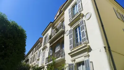a white building with windows and balconies at VIA ITALIA AP1054 - By Riviera Holiday Homes in Nice