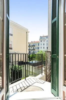 an open door to a balcony with a view of a building at Suite ST Geneviève Five stars holiday house in Nice