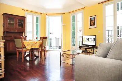 a living room with a table and a couch at Suite ST Geneviève Five stars holiday house in Nice
