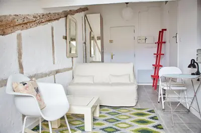 a living room with white chairs and a table at Studio Côte Blanche - Welkeys in Nice