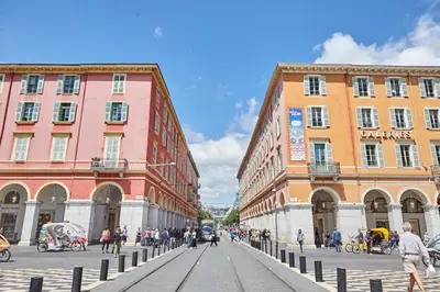 a group of people walking on a street in front of buildings at Studio Côte Blanche - Welkeys in Nice