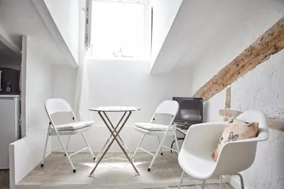 a room with three chairs and a table with a computer at Studio Côte Blanche - Welkeys in Nice