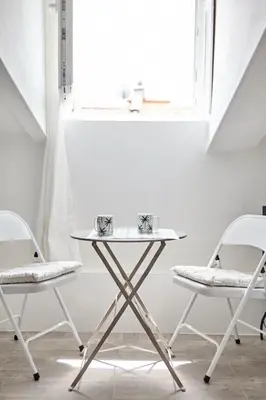 a table and two chairs in front of a window at Studio Côte Blanche - Welkeys in Nice