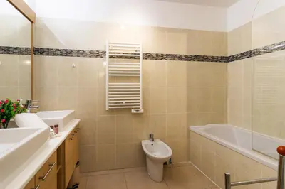 a bathroom with a sink and a toilet and a bath tub at JARDINS MASSENA AP4088 Nice, by Riviera Holiday Homes in Nice