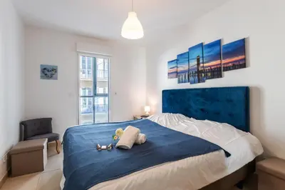 a bedroom with a bed with two stuffed animals on it at JARDINS MASSENA AP4088 Nice, by Riviera Holiday Homes in Nice