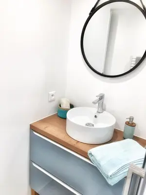 a bathroom with a sink and a mirror at Homelivia, Appart FRIDA, mezzanine, déco raffinée et balcon in Nice