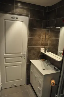 a bathroom with a white sink and a mirror at Charmant studio tout proche du port in Nice