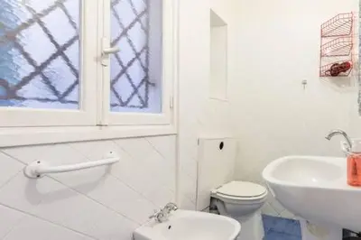 a kitchen with white cabinets and a black refrigerator at Prefecture Duplex - Old Town in Nice