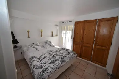 a bedroom with a bed and a window at La Plenitude in Cagnes-sur-Mer