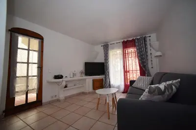 a living room with a couch and a table at La Plenitude in Cagnes-sur-Mer