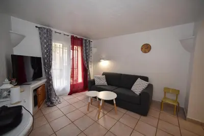 a living room with a couch and a table at La Plenitude in Cagnes-sur-Mer