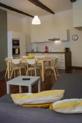 a kitchen and dining room with a table and chairs at Magnifiques Appartements au coeur du Vieux Nice in Nice
