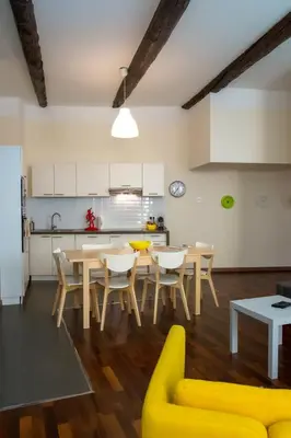 a kitchen and dining room with a table and chairs at Magnifiques Appartements au coeur du Vieux Nice in Nice