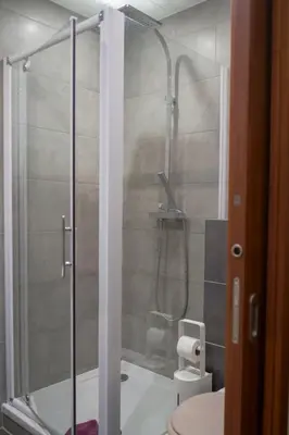 a bathroom with a shower with a toilet and a tub at Magnifiques Appartements au coeur du Vieux Nice in Nice