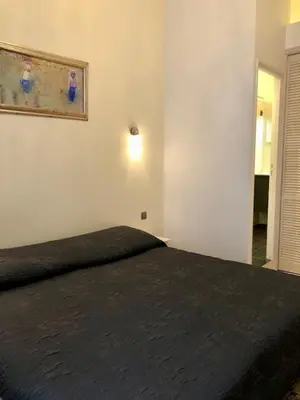 a bedroom with a black bed in a room at Hotel Cresp in Nice