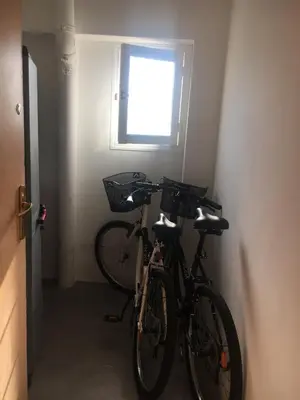 two bikes parked in a room with a window at Charmant 2 pièces à 50 M de la mer in Cros-de-Cagnes
