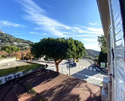 a tree on the side of a building with a street at Hôtel La Villa d'Eze in Èze