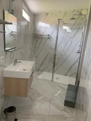 a white bathroom with a sink and a shower at Hôtel La Villa d'Eze in Èze