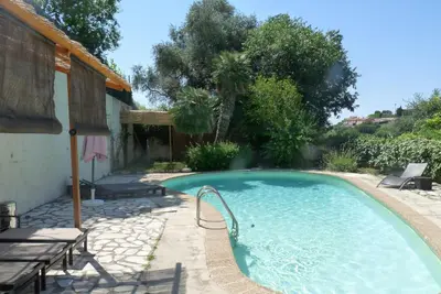 a swimming pool in the backyard of a house at Castel Enchanté in Nice