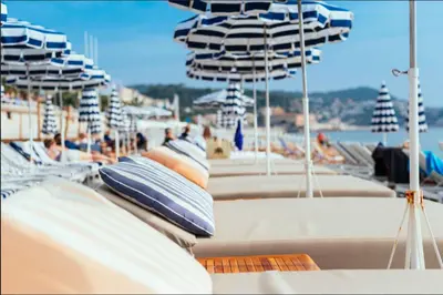a boat with blue and white umbrellas on it at Unique sea view apartment, center, 100m2 in Nice